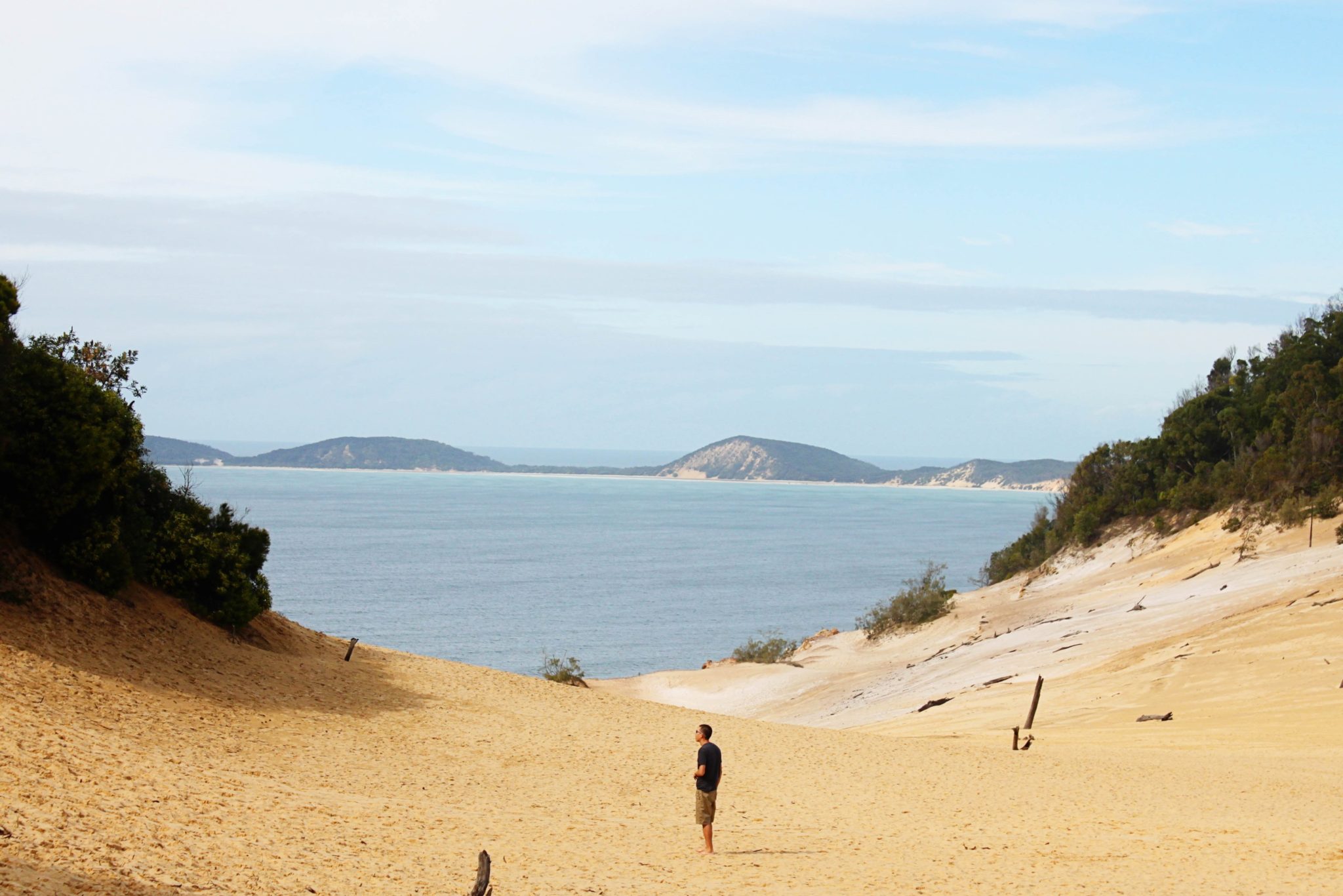 Take the Carlo Sand Blow Track in the Great Sandy National Park to see some spectacular dunes over looking the beach- 7 unforgettable things to do along Australia's Sunshine Coast #australia #sunshinecoast #greatsandynationalpark #simplywander